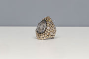 Todd Reed ring with a fancy cut diamond (8.49ctw), natural grey colored diamonds (1.61ctw) and natural colored olive diamonds (4.06ctw) in palladium.